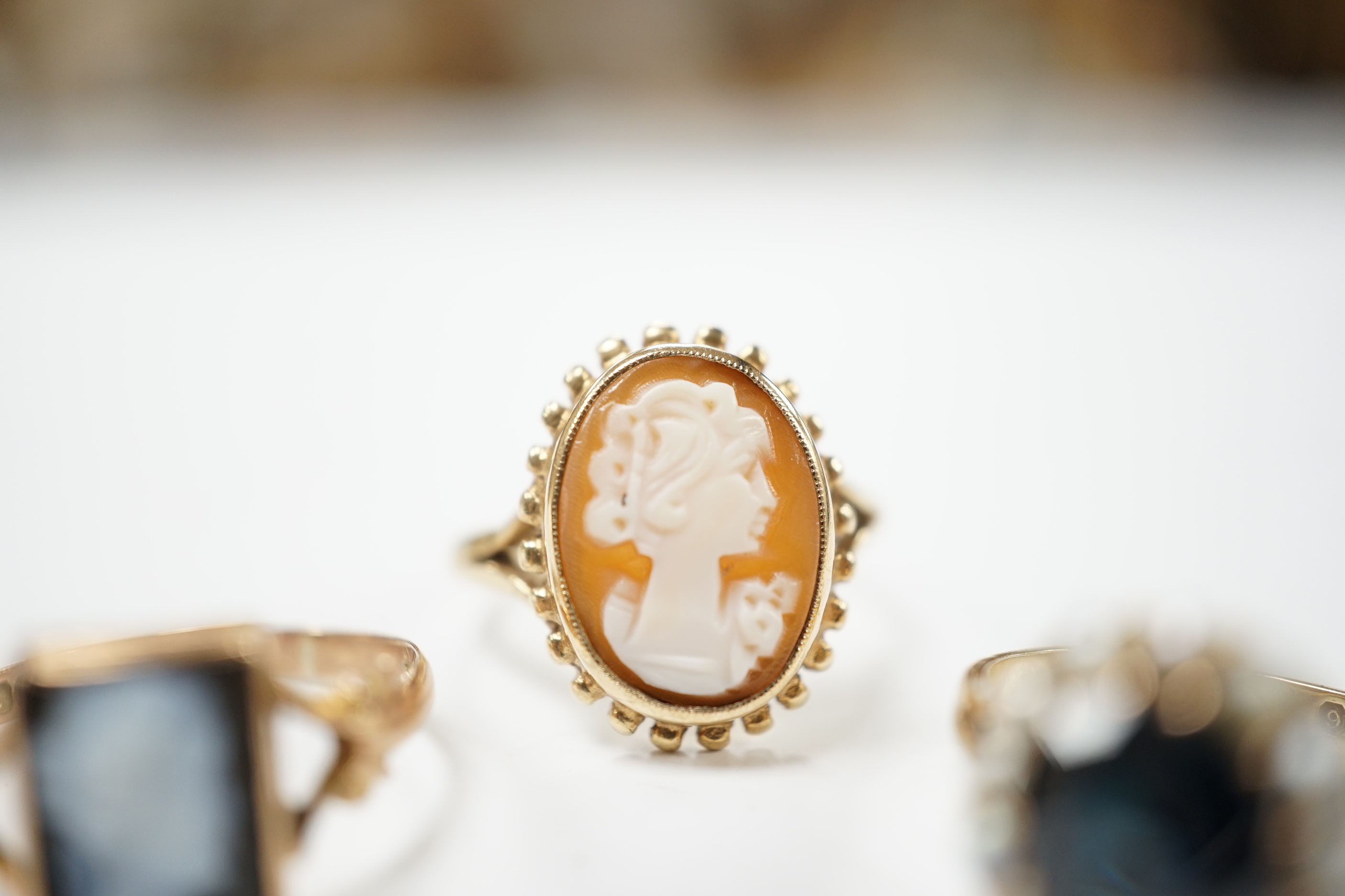 Two 9ct gold cameo rings, size N and Q, and a pearl and sapphire cluster ring, size N
